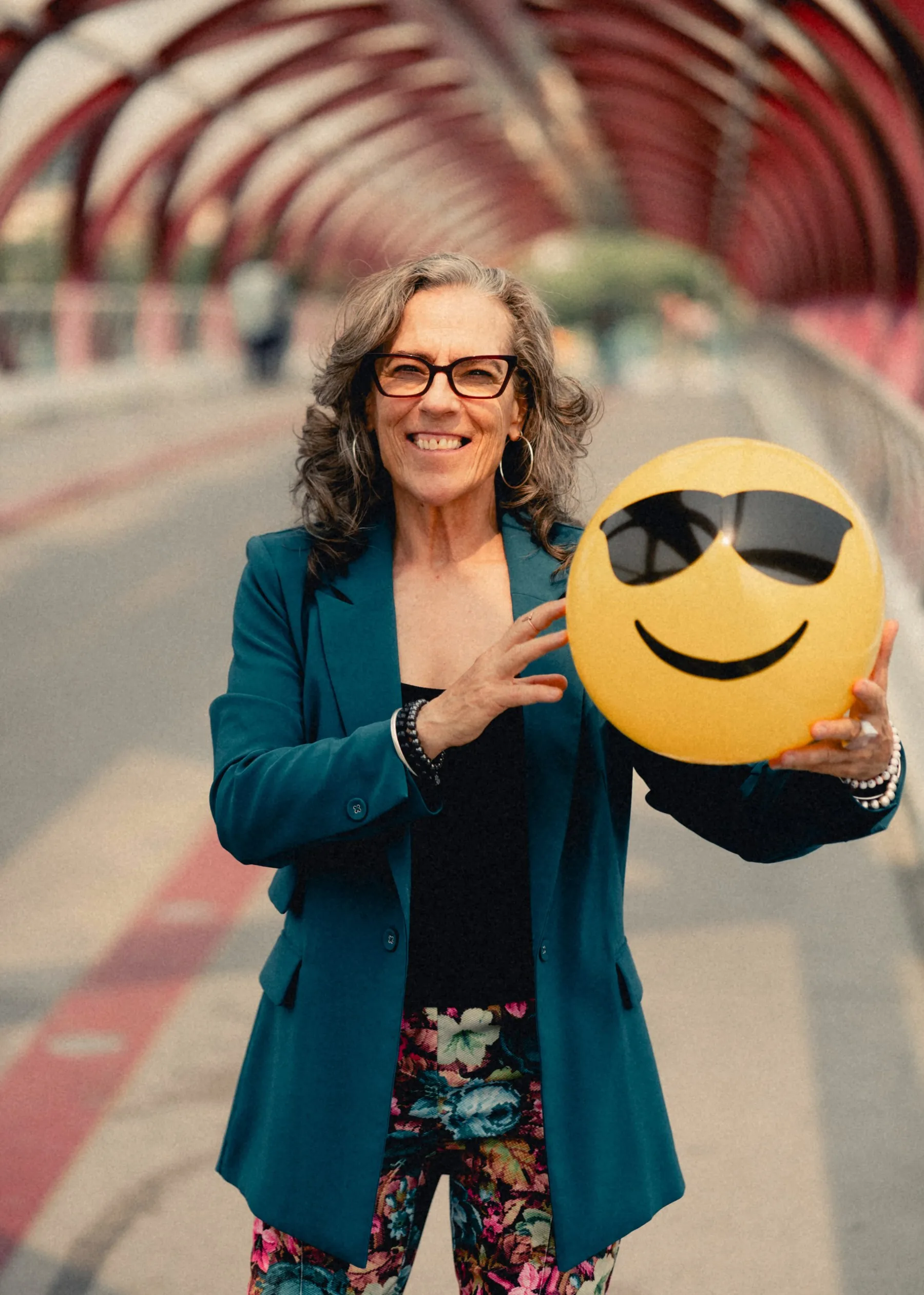 Heidi holding a smiley-face ball on the Peace Bridge