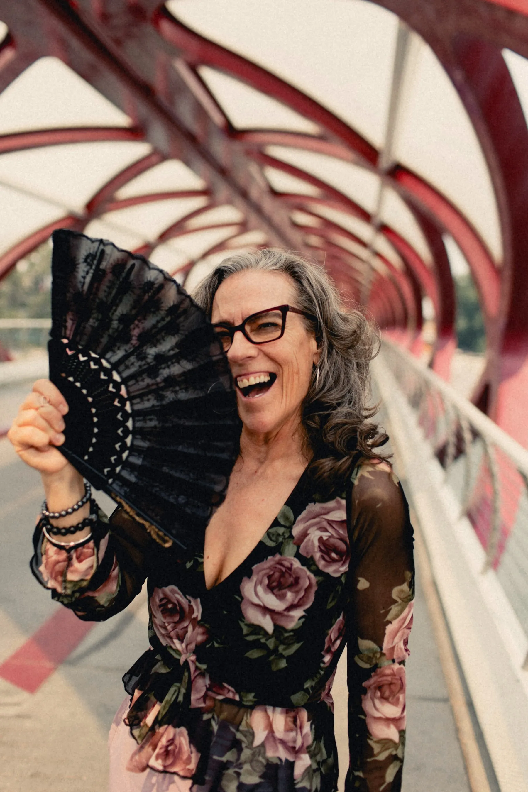 Heidi laughing behind a black lace fan