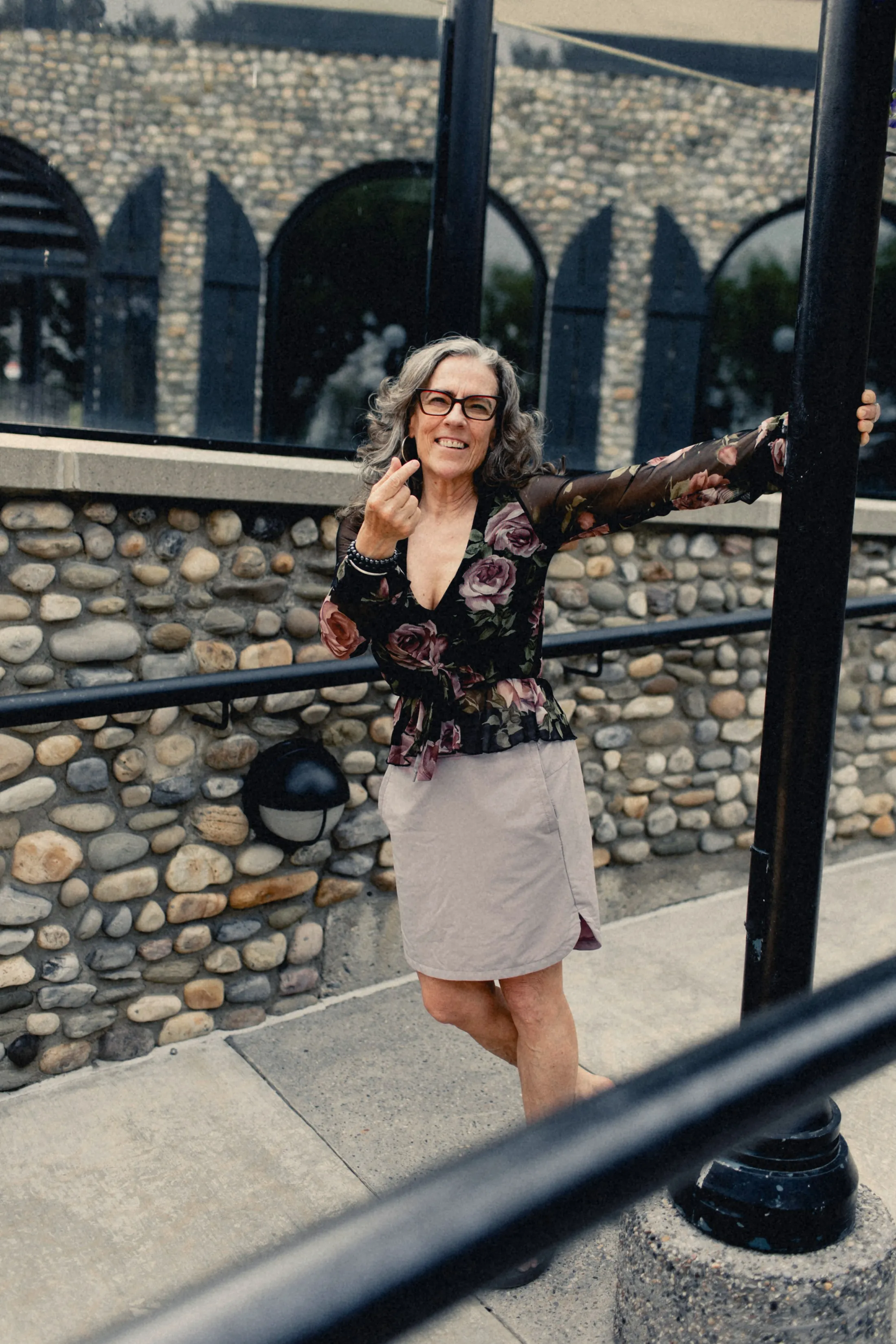 Heidi with her arms out on stone steps