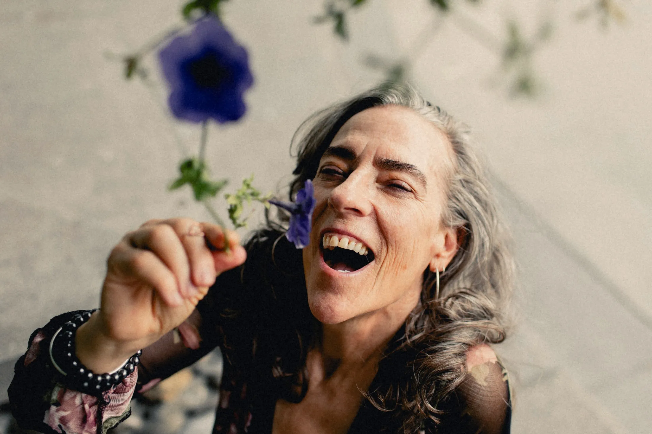 Heidi laughing among purple flowers