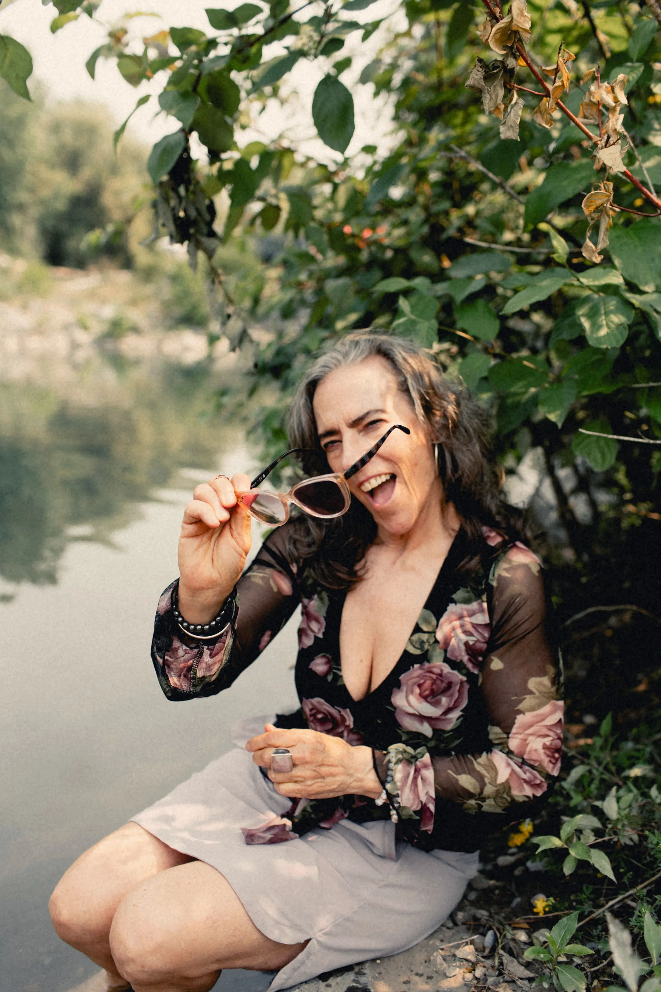 Heidi lifting her sunglasses, laughing