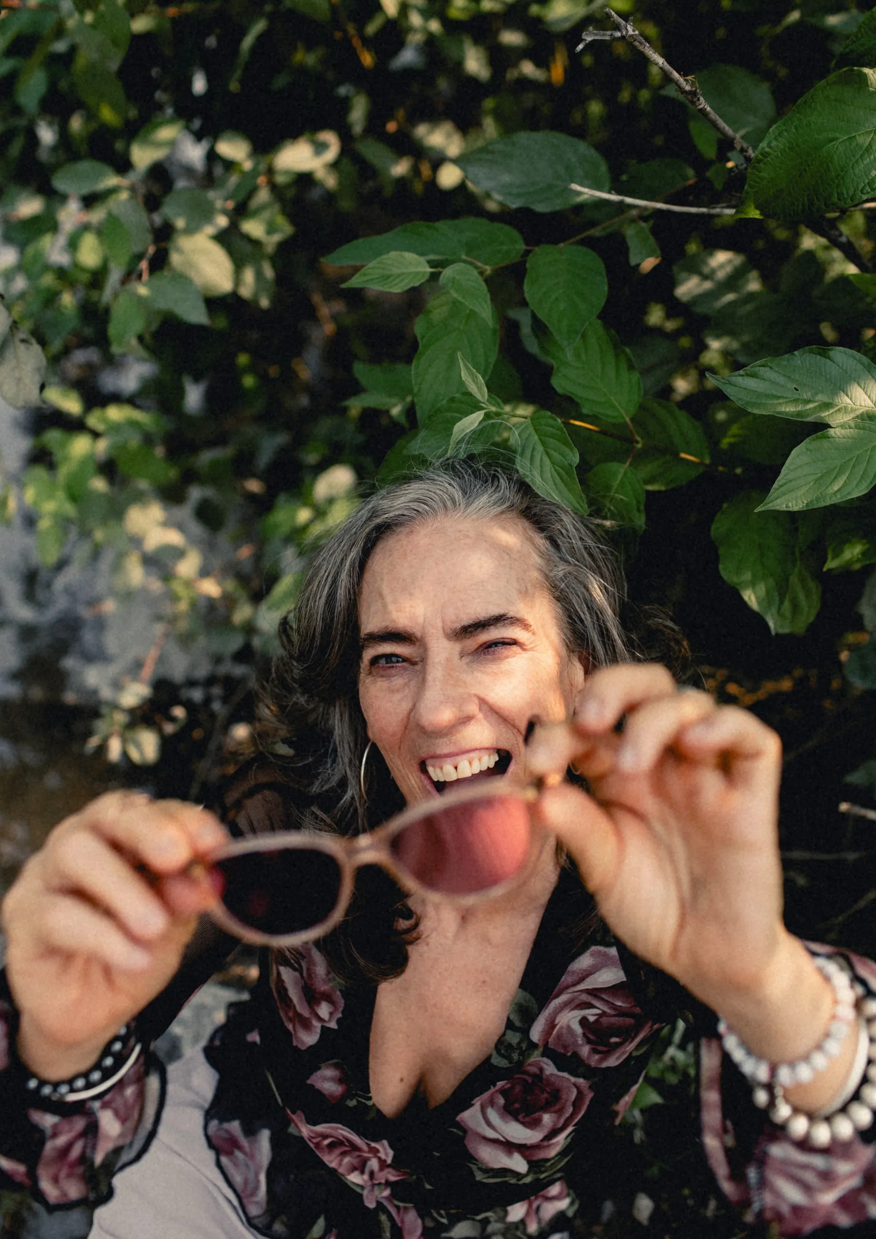 Heidi peeking over her sunglasses, laughing
