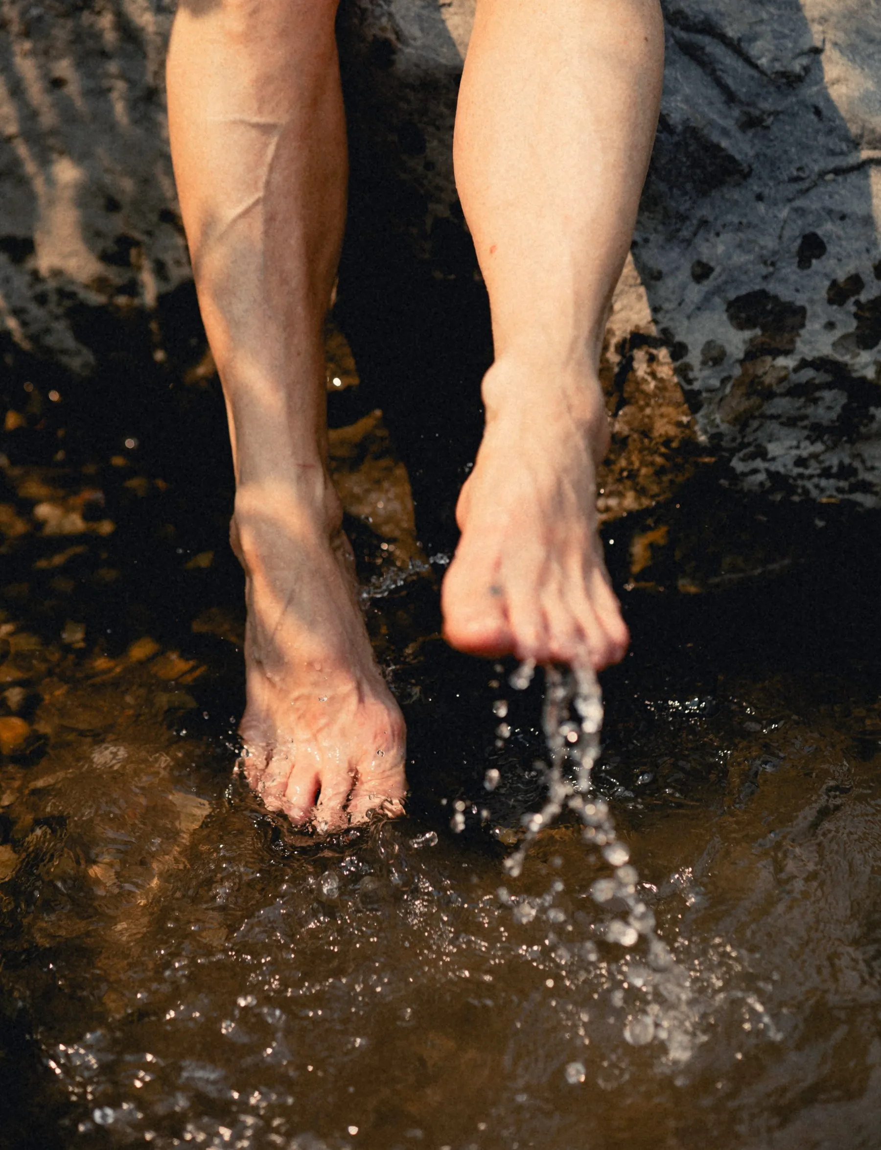 Feet splashing in the Bow River