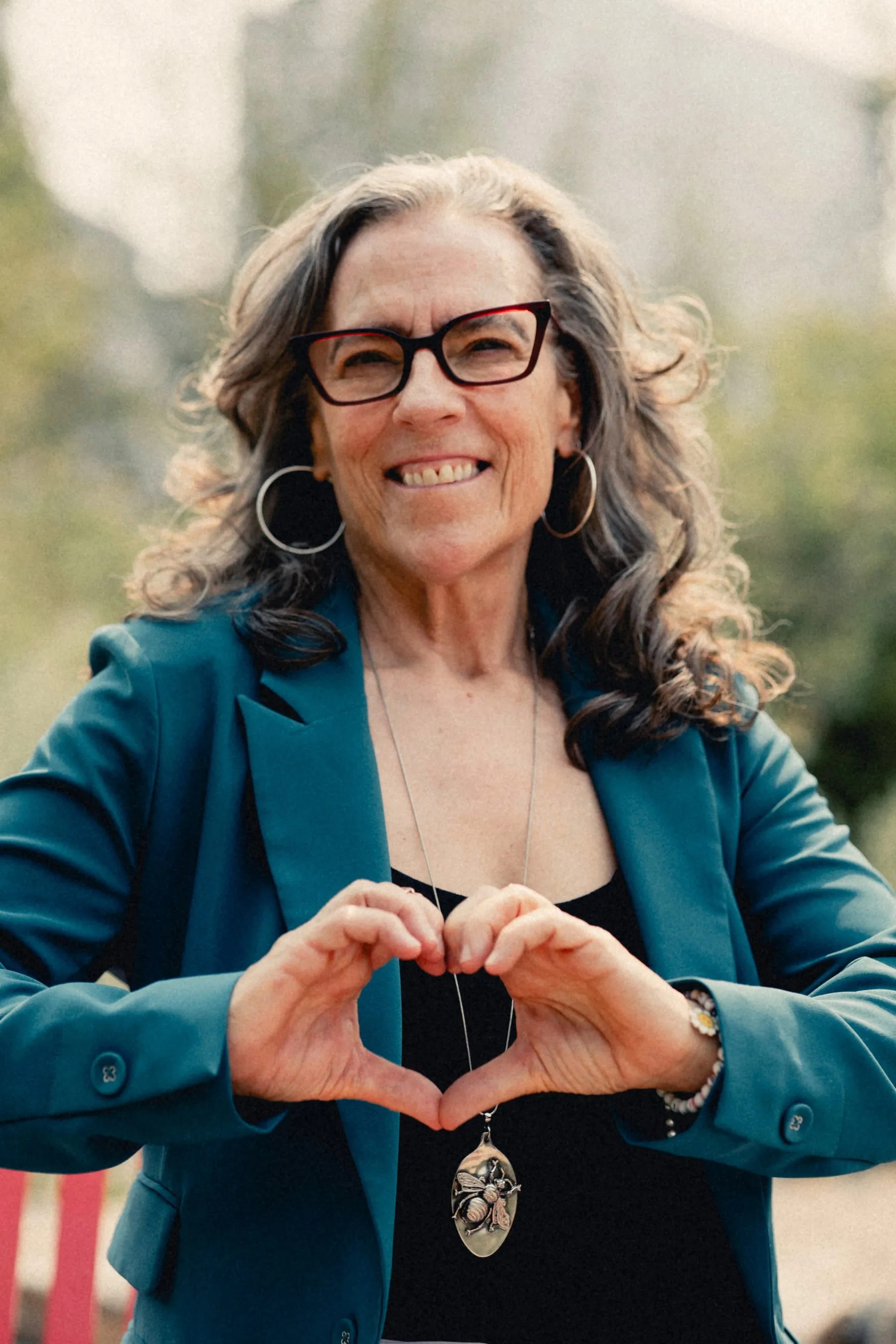 Heidi making a heart with her hands